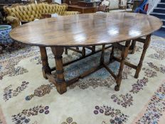 An 18th century style oak gateleg wake table, length 250cm, width 154cm extended, height 75cm