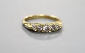 An early 20th century 19ct gold and graduated five stone diamond set half hoop ring, size G, gross