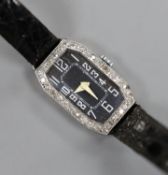 A lady's white metal (stamped platinum) and diamond set cocktail watch, on a leather strap, cased