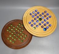 Two solitaire sets, largest 35 cms diameter.