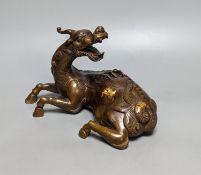 A Chinese parcel-gilt bronze incense burner and cover, modelled as a recumbent qilin, Qing