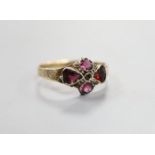 A Victorian 12ct gold and four stone garnet and amethyst set dress ring, size O, gross 1.7 grams.