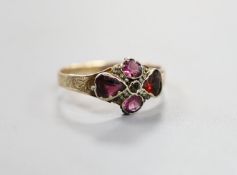 A Victorian 12ct gold and four stone garnet and amethyst set dress ring, size O, gross 1.7 grams.