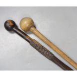 An ebony knobkerrie, 91 cms long, and another.