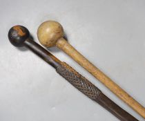 An ebony knobkerrie, 91 cms long, and another.