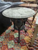A Victorian cast iron Britannia table with circular weathered wood top, diameter 58cm, height 69cm
