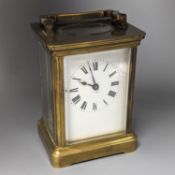 A French brass carriage timepiece, 14cm. including handle