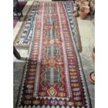 A Kilim polychrome flatweave runner, 380 x 118cm (holed)