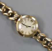 A lady's 1960's 9ct gold Jaeger Le Coultre back wind wrist watch, on a 9ct gold curb link bracelet,