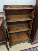 A reproduction 18th century style oak graduated open bookcase, width 60cm, depth 27cm, height 104cm