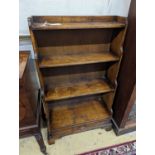 A reproduction 18th century style oak graduated open bookcase, width 60cm, depth 27cm, height 104cm