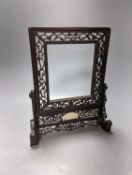 A Chinese hardwood carved table screen, frame and stand, 30 cms high.