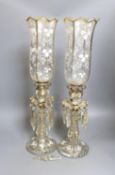 A pair of white-enamelled glass lustre storm lamps, 55cms high.