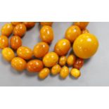 A single strand graduated oval amber bead necklace, 43cm, gross weight 51 grams and a few loose