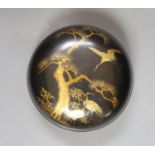 A Japanese lacquer box and cover, 21 cms diameter.