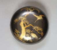 A Japanese lacquer box and cover, 21 cms diameter.