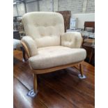 An Ercol Jubilee beech armchair with loose cushion upholstery, width 77cm, depth 80cm, height 86cm