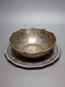 A Persian engraved white metal bowl, diameter 17.9cm and a similar stand or plate, 22cm, 20oz.