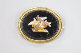 A Victorian yellow metal mounted oval micro mosaic brooch, decoration with the Pliny doves, 38mm.