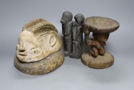 A tribal figural stool (15.5cm), similar mask head-dress and two smaller hardwood carvings