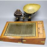 A Victorian walnut writing slope and a set of Victorian cast iron scales and weights (2), writing