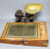 A Victorian walnut writing slope and a set of Victorian cast iron scales and weights (2), writing
