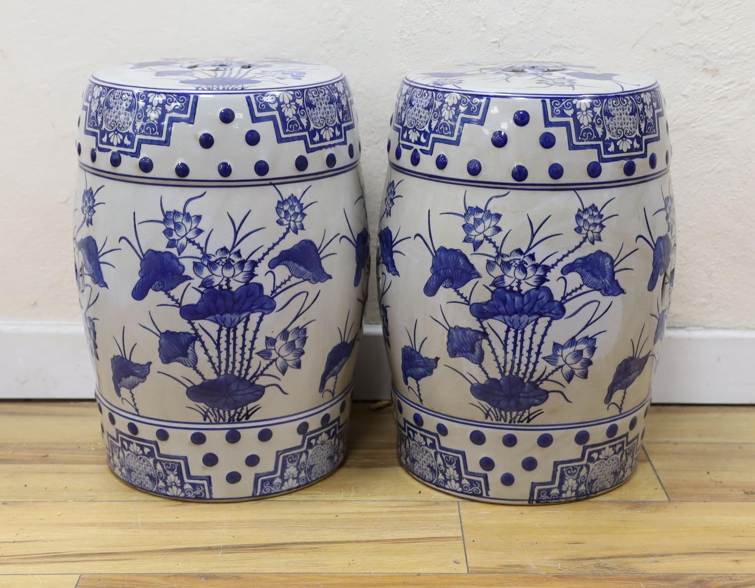 A pair of Chinese blue and white garden seats, 44 cms high.