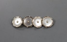 A cased pair of 18ct, 9ct, mother of pear and seed pearl set circular cufflinks, 13mm, gross