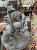 A pair of cast metal garden ornaments modelled as geese, larger height 51cm