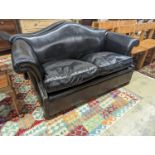 A pair of black leather scroll arm two seater settees on flat bun feet, length 184cm, depth 80cm,