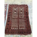 An Afghan red ground prayer rug, 166 x 120cm