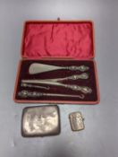 A George V silver cigarette case, an earlier silver vest case and a cased set of button hooks,
