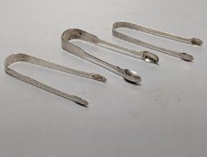 Two pairs of George III bright cut engraved silver sugar tongs and a pair of George IV silver