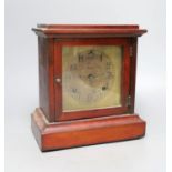 An Edwardian walnut mantel clock, 26cms high.