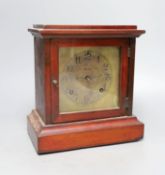 An Edwardian walnut mantel clock, 26cms high.