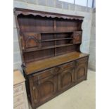 A Georgian style oak dresser base with boarded rack, W-184cm, D-46cm, H-188cm.