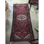 A Hamadan red ground rug, 190 x 82cm