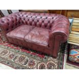 A Victorian style buttoned burgundy leather Chesterfield settee, length 172cm, depth 90cm, height
