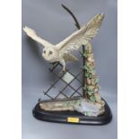 A large ceramic barn owl, on stand, 64 cms high.