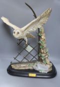 A large ceramic barn owl, on stand, 64 cms high.