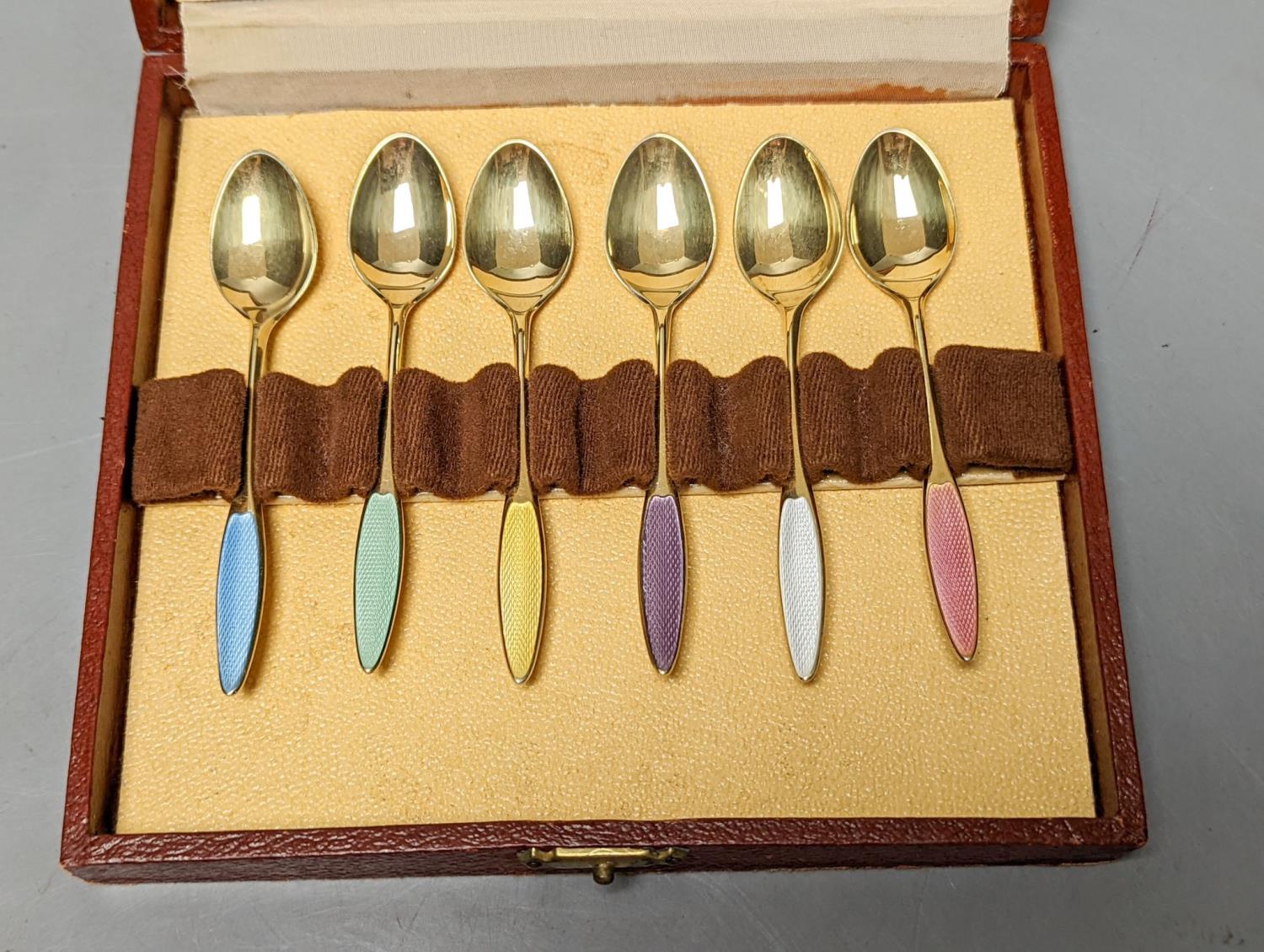 A cased set of six Danish Fricast gilt sterling and enamel coffee spoons.