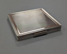 A 1960's Garrard & Co yellow metal mounted engine turned silver cigarette case, Birmingham, 1965,