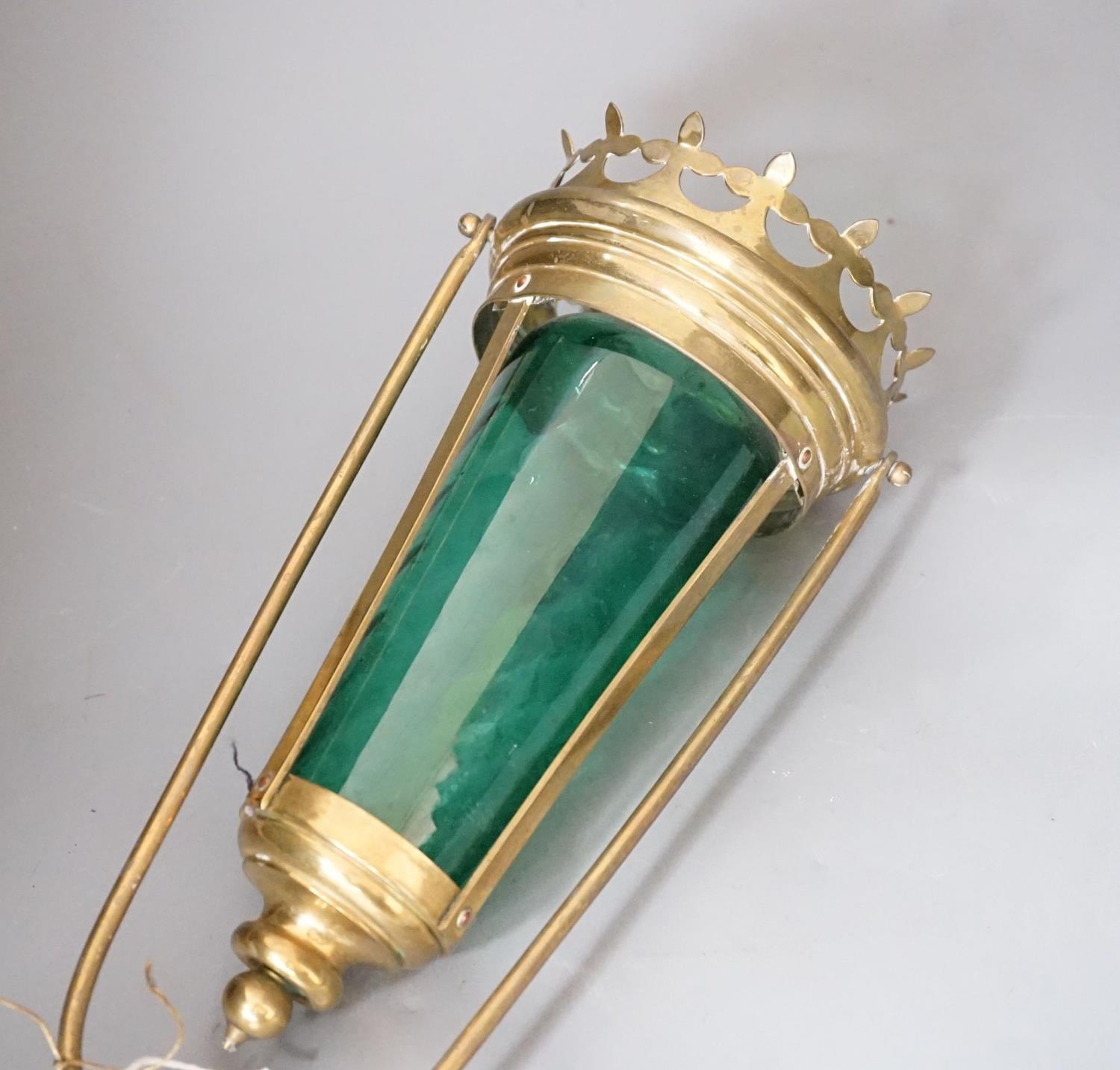 A brass and green glass processional lantern, with docking port,90 cms high.