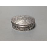 A Persian engraved white metal circular box and cover, 86mm,147 grams.