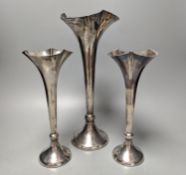 A large George V silver mounted trumpet vase, 34cm and a pair of smaller silver mounted vases.