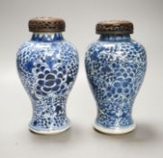 A pair of Chinese blue and white 'phoenix' vases, Kangxi, associated wood covers, 19cm including