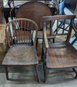 A 19th century elm and ash primitive Windsor comb back chair with traces of original paint, two