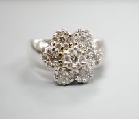 A modern 14k white metal and seven stone diamond set multi-cluster flower head dress ring, size M/N,