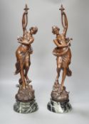 A pair of bronze female dancers, on marble plinths, 47cm