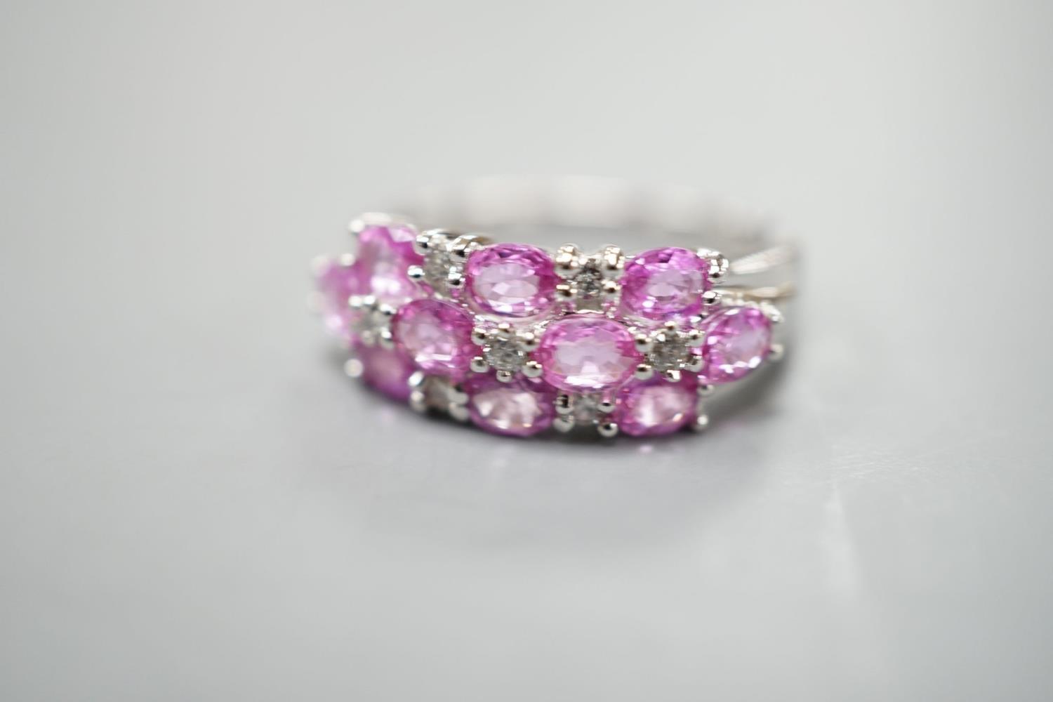 A modern 14k white metal, pink sapphire and diamond cluster set half hoop dress ring, size O, - Image 2 of 2